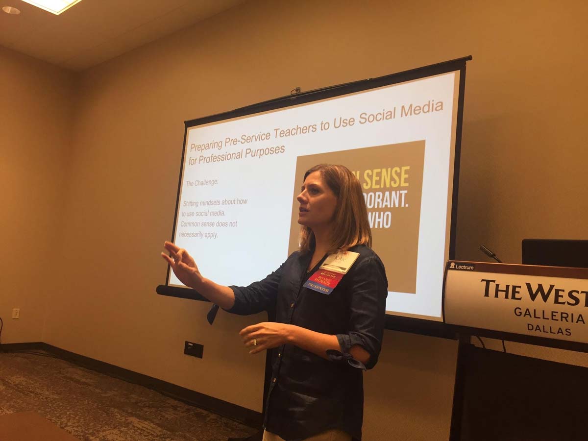 A woman speaking in front of a powerpoint presentation